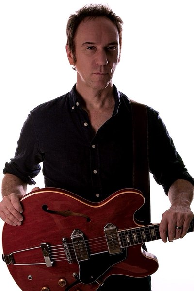 Doug Gillard with red hollowbody guitar